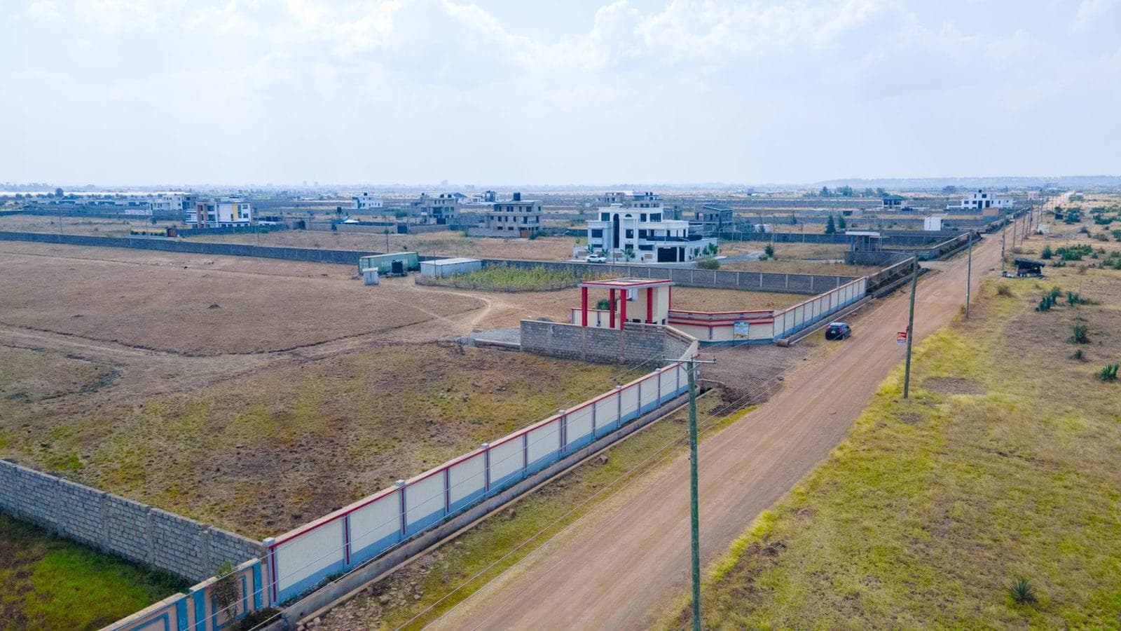 Branded perimeter wall along the Jewels Delight Garden access road